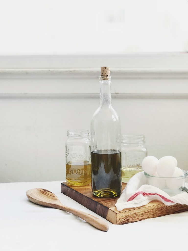 Side angle shot of jars and bottles of olive oil.