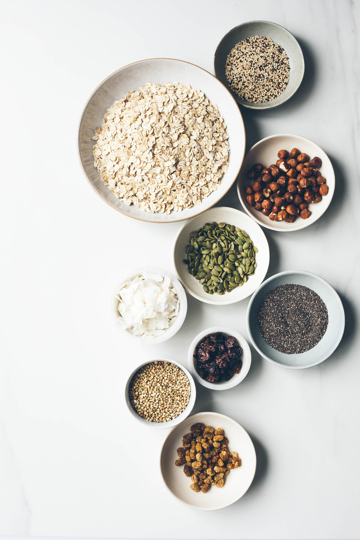 Overhead shot of bowls of ingredients for making granola