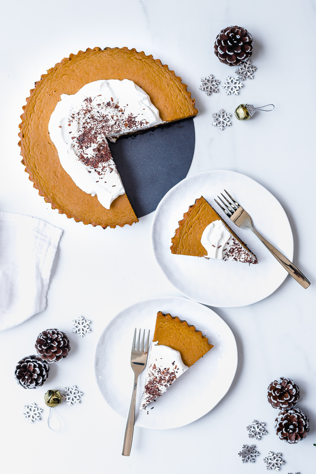 Overhead shot of Pumpkin Pie with slices served onto plates