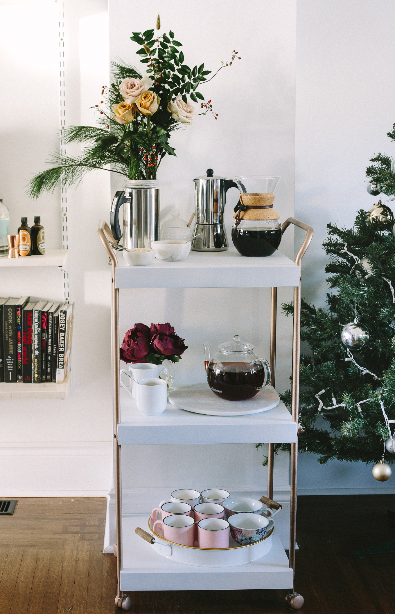 Straight-on shot of a beautiful bar cart filled with all things hip, modern coffee and tea.