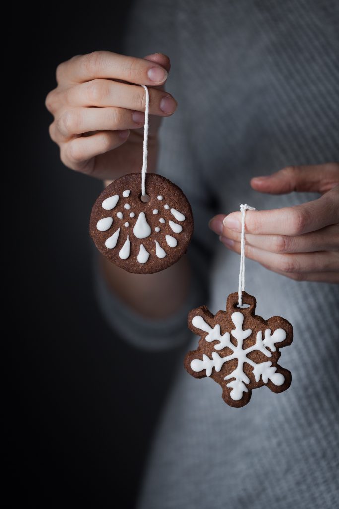 hand holding an Edible Gingerbread Cookie Ornaments.