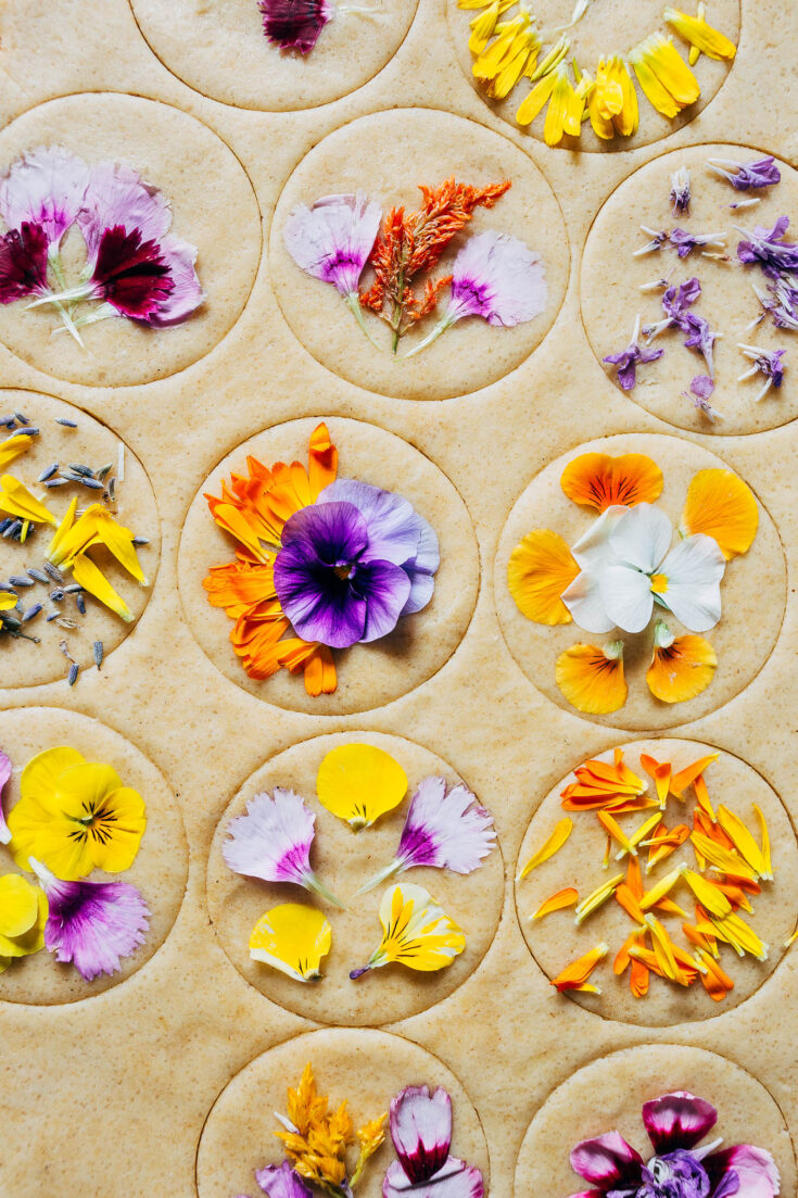 Cookie dough cutouts topped with edible flower petals.