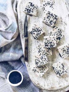 Overhead shot of small rounds of Frozen Tahini and Black Sesame Fudge on a cutting board