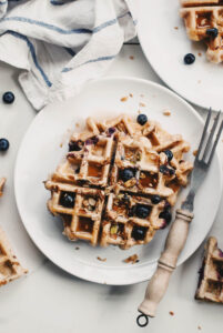 Overhead shot of granola rye waffles on a table.