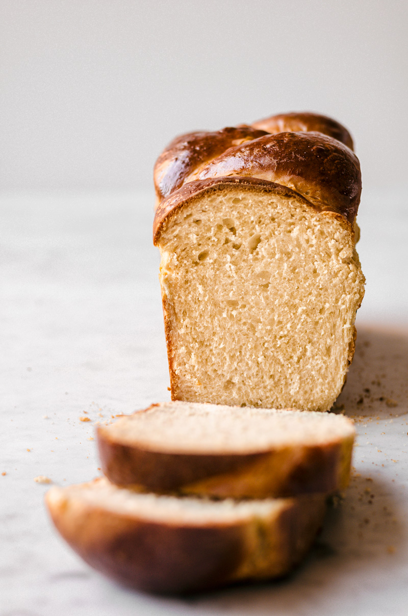 Head on image of brioche bread with two slices taken off.