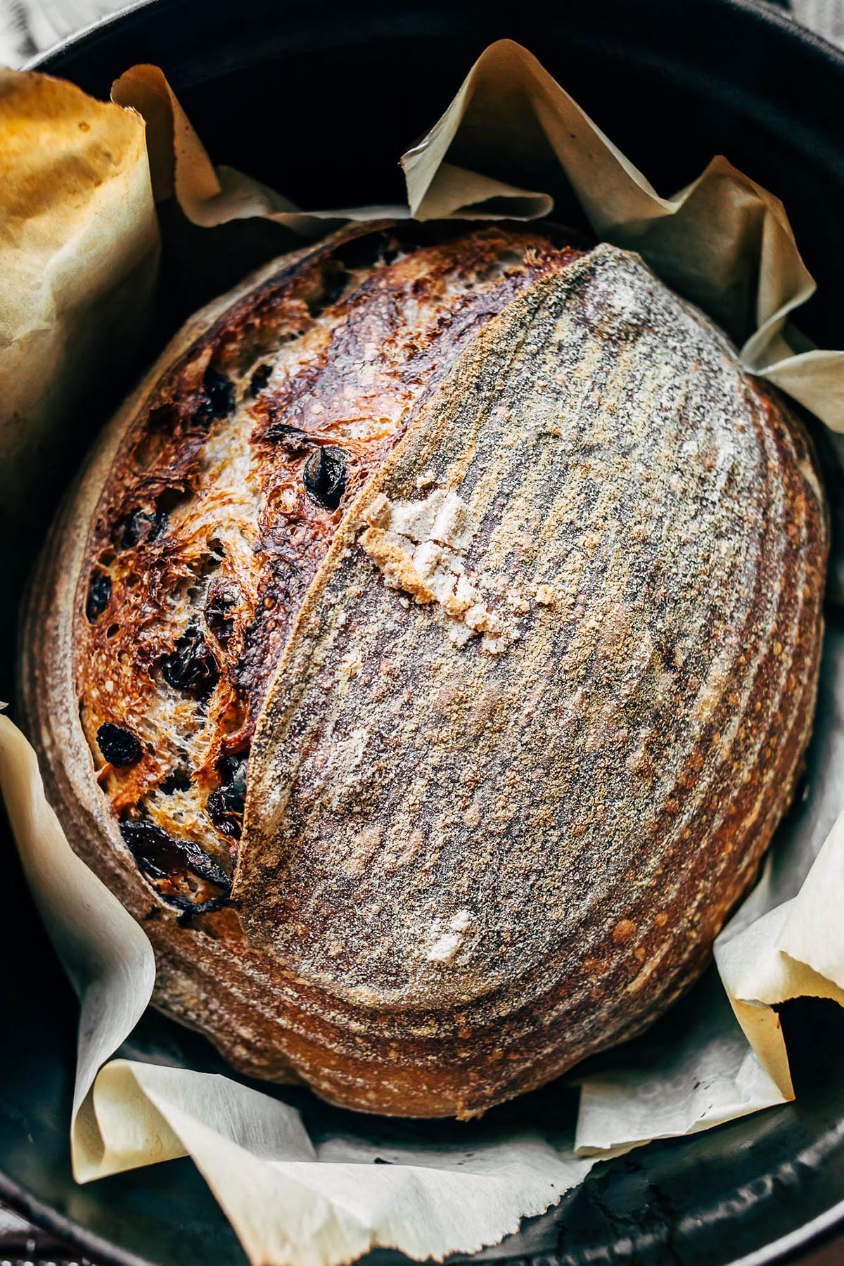overhead image of a loaf of baked cinnamon raisin sourdough bread.