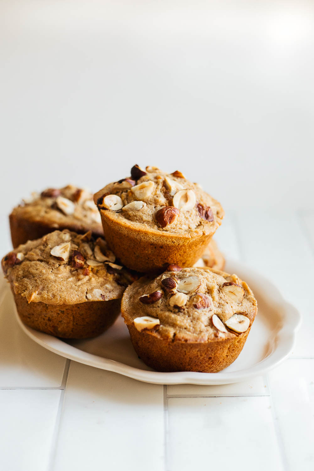 A stack of sourdough morning glory muffins on a platter.