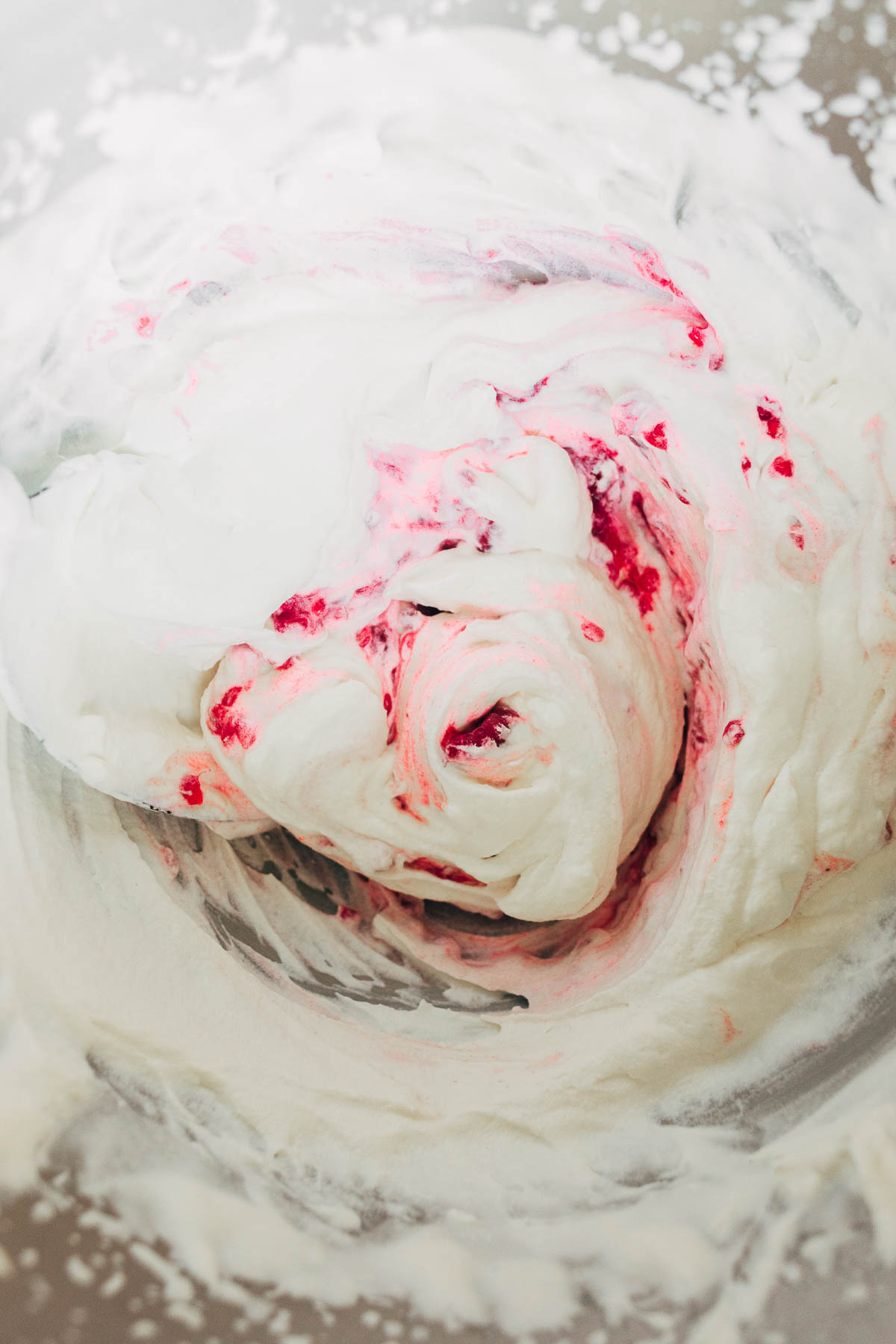 Raspberries swirled into whipped cream.