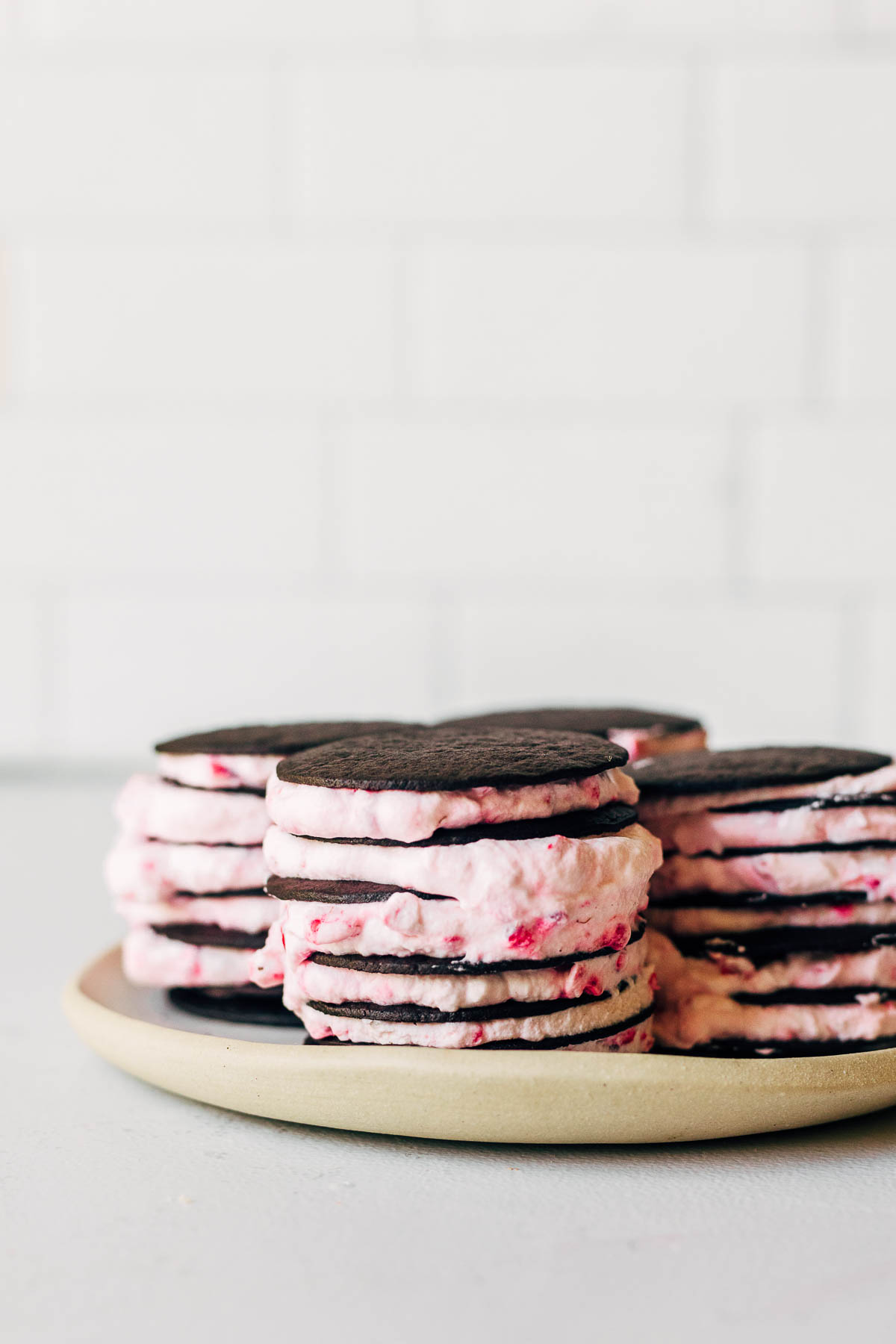 Chocolate wafer cookies stacked with raspberry whipped cream.