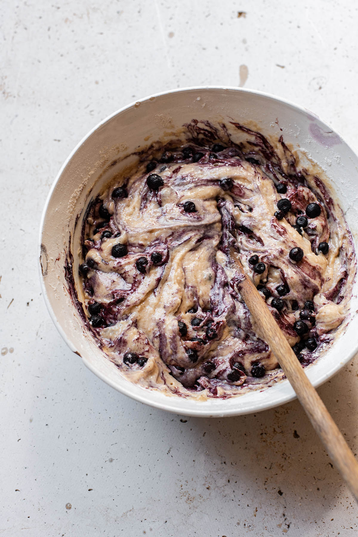 Blueberry muffin batter in a large bowl.