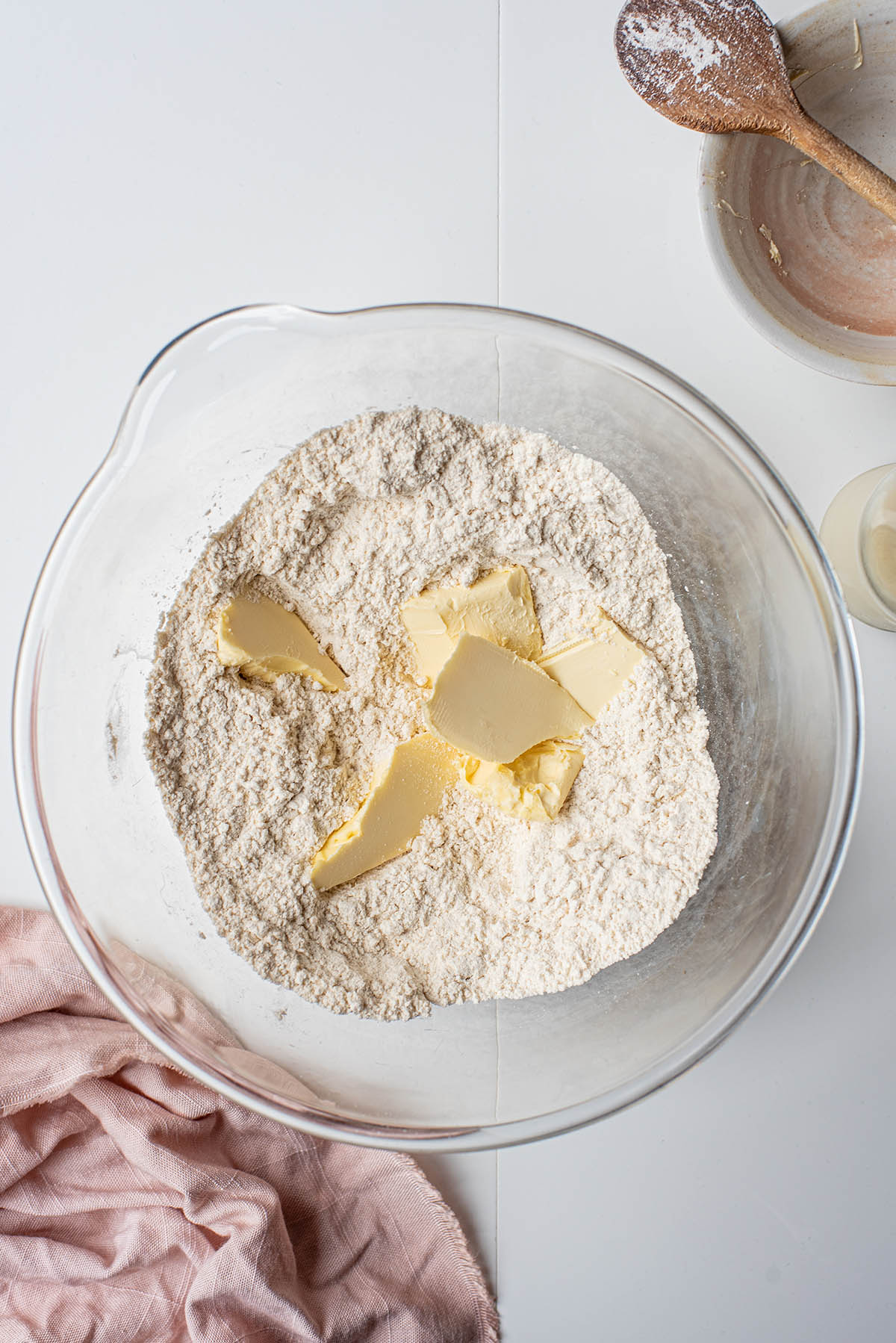 Chunks of vegan butter added to dry ingredients.