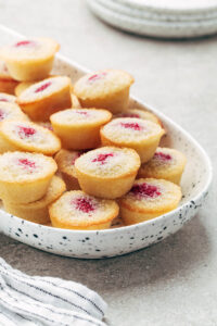 Financiers piled into a speckled serving tray.