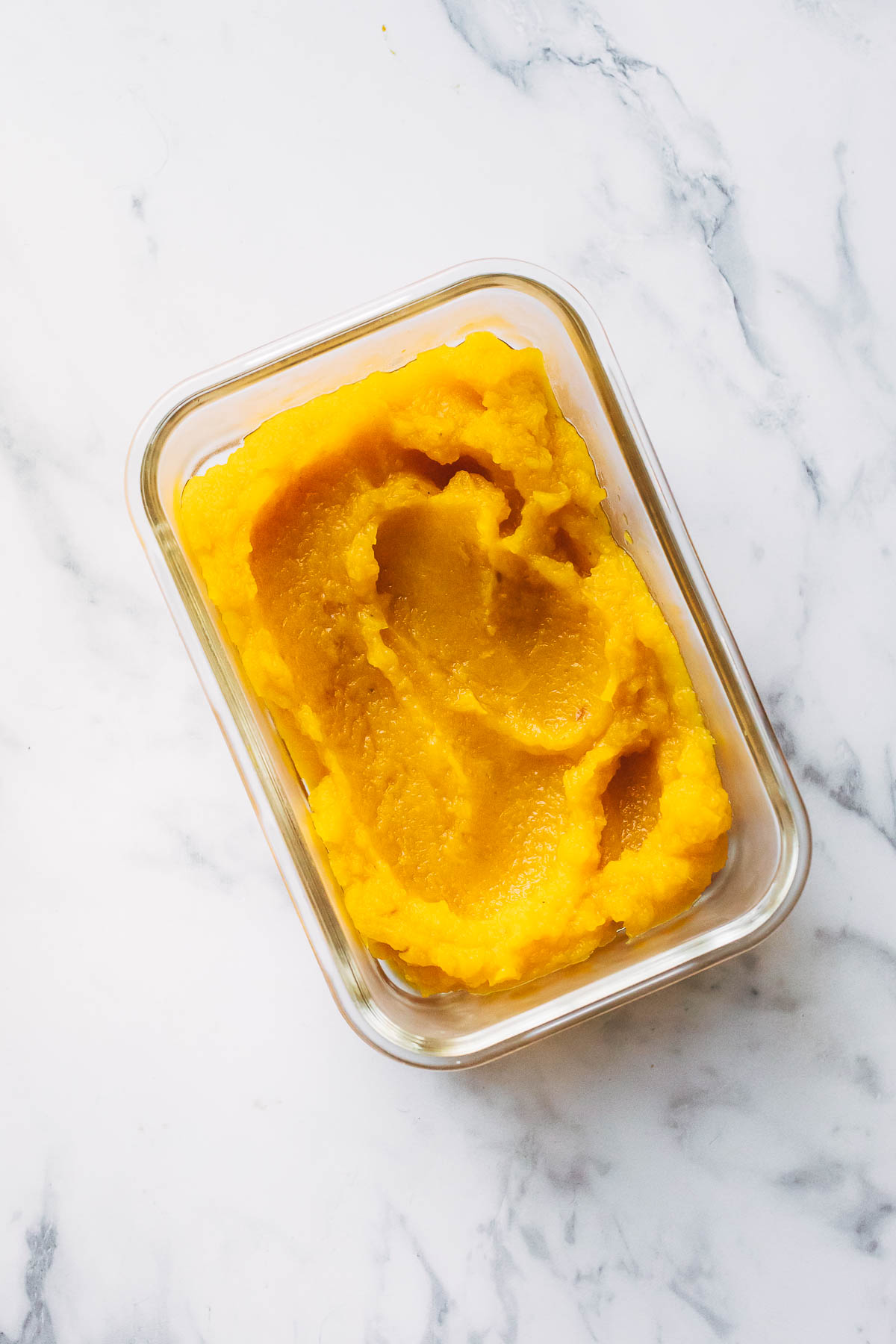 A rectangle glass dish filled with homemade pumpkin purée.