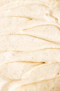 Close up of cream cheese frosting with vanilla specks.