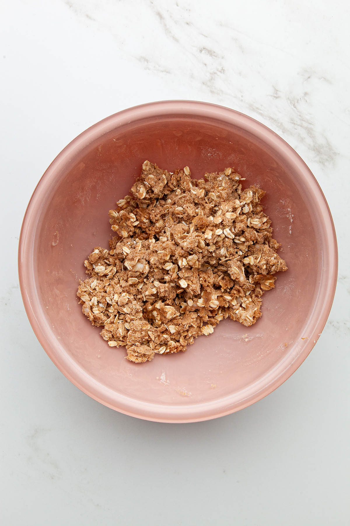 A bowl of mixed oat crumble topping.