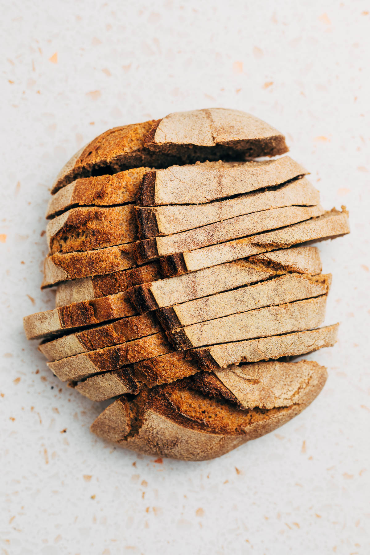 A loaf of sourdough bread, sliced, overhead shot.