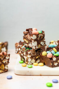 Small squares of Easter rocky road with more small candies around.