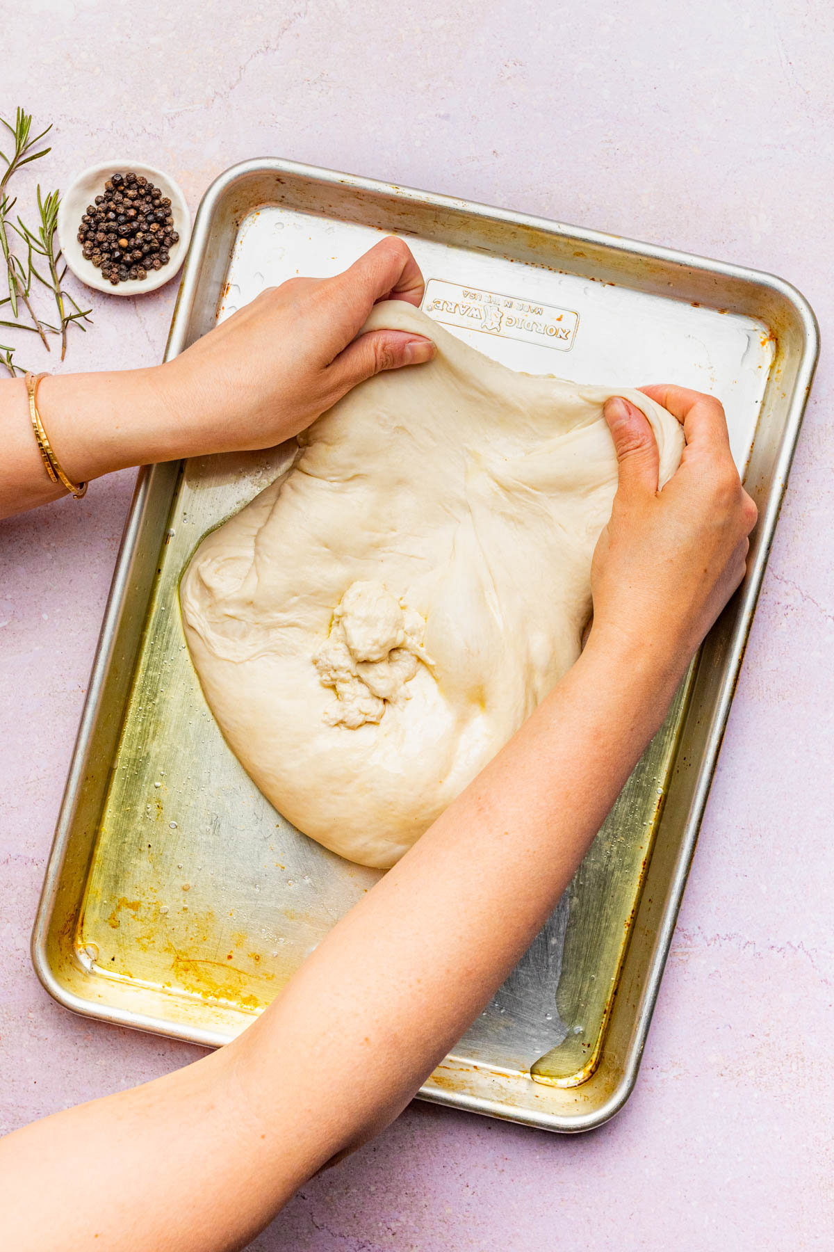 Stretching the dough out.