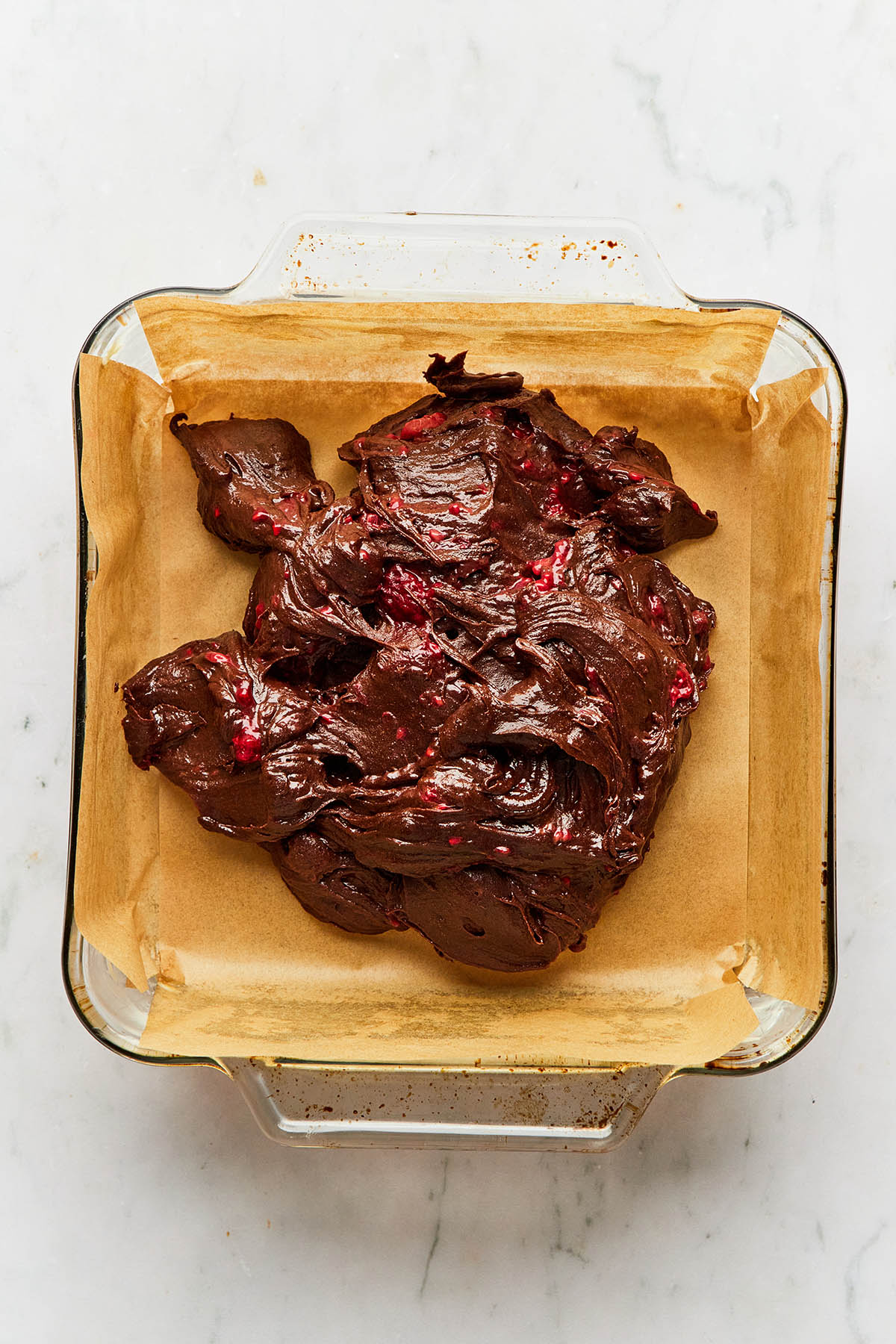 Un-smoothed chocolate batter inside a baking dish.