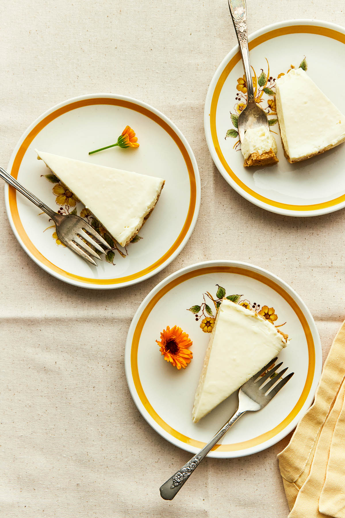 Three slices of gluten-free no-bake cheesecake on plates.