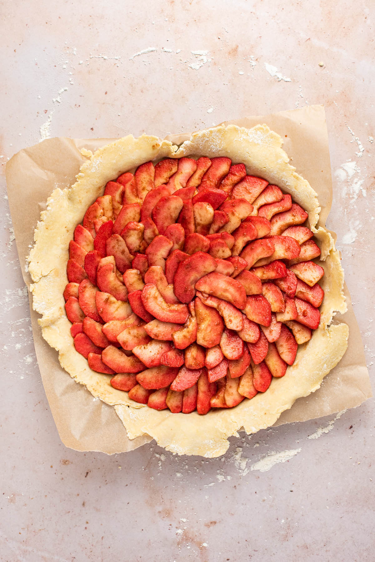 Sliced apples arranged in a spiral in the pastry.
