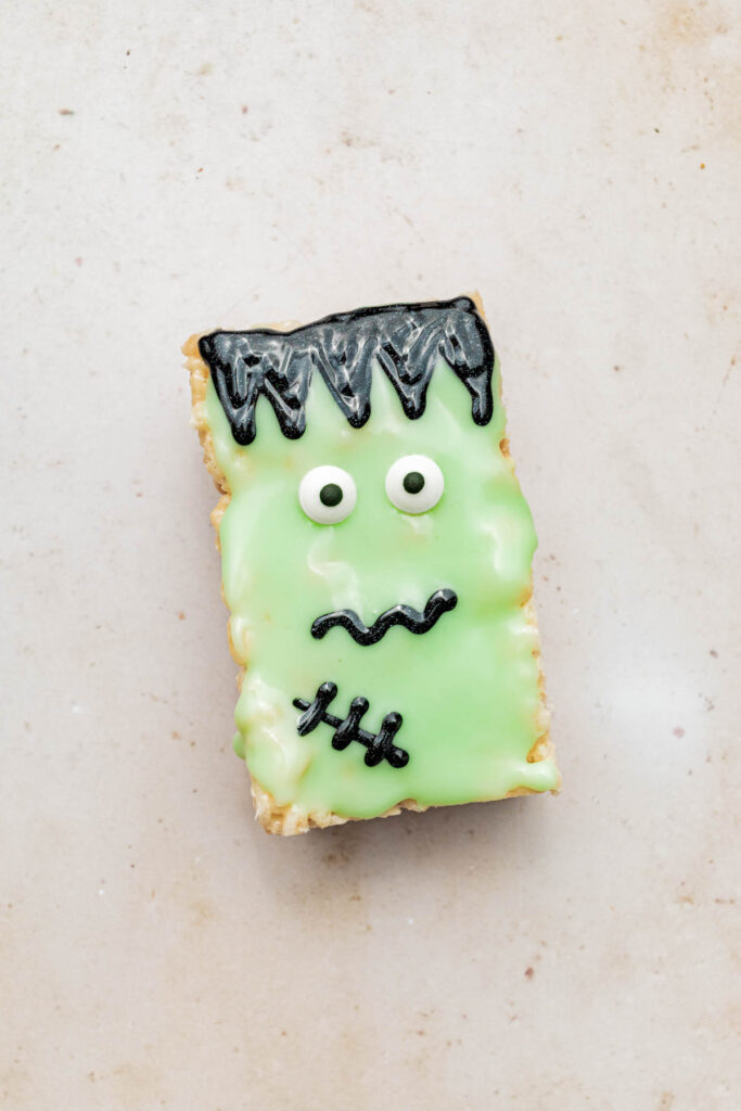 Monster treat with black hair, scar, and wriggly mouth.