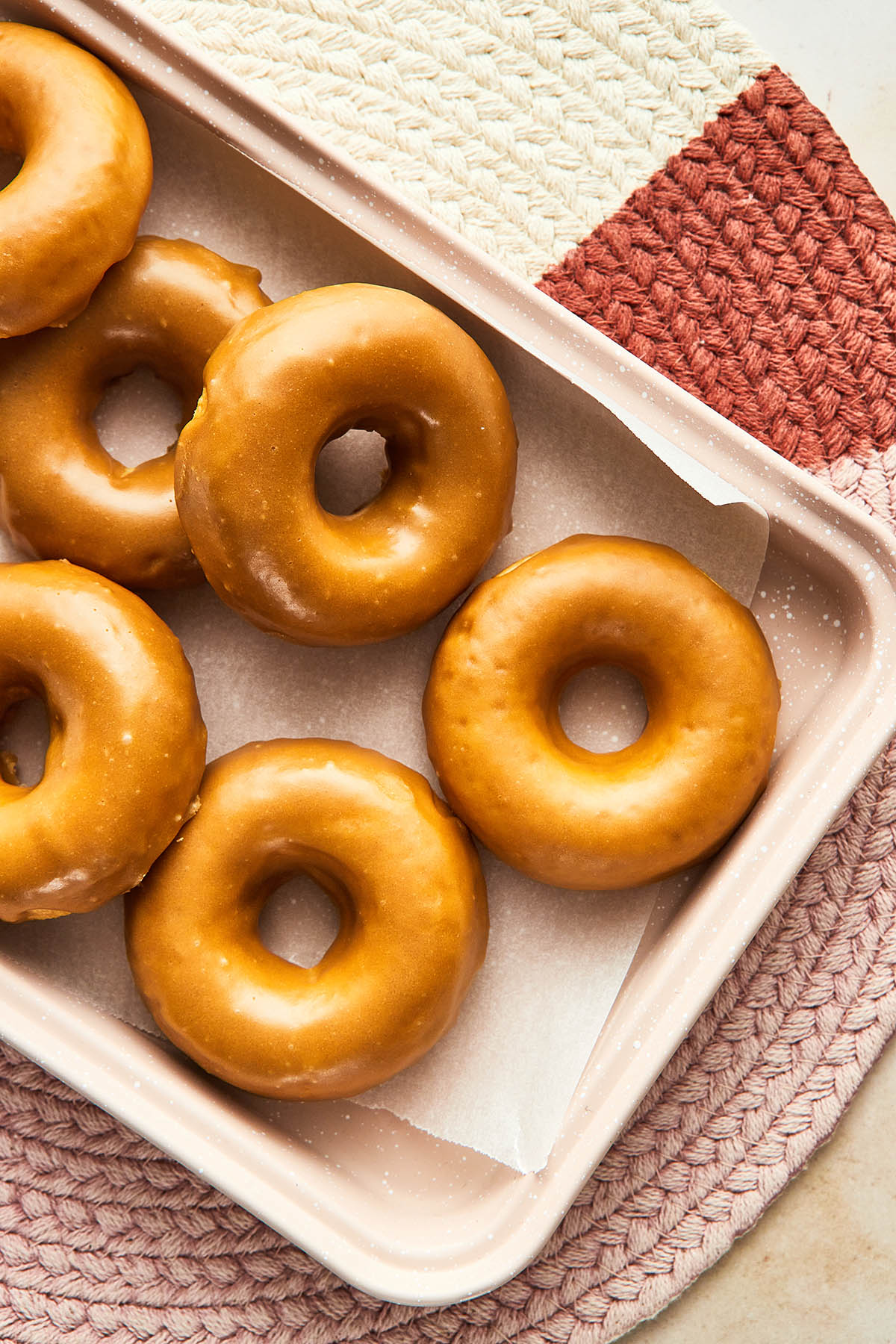 A pan of oven-baked maple glazed donuts.