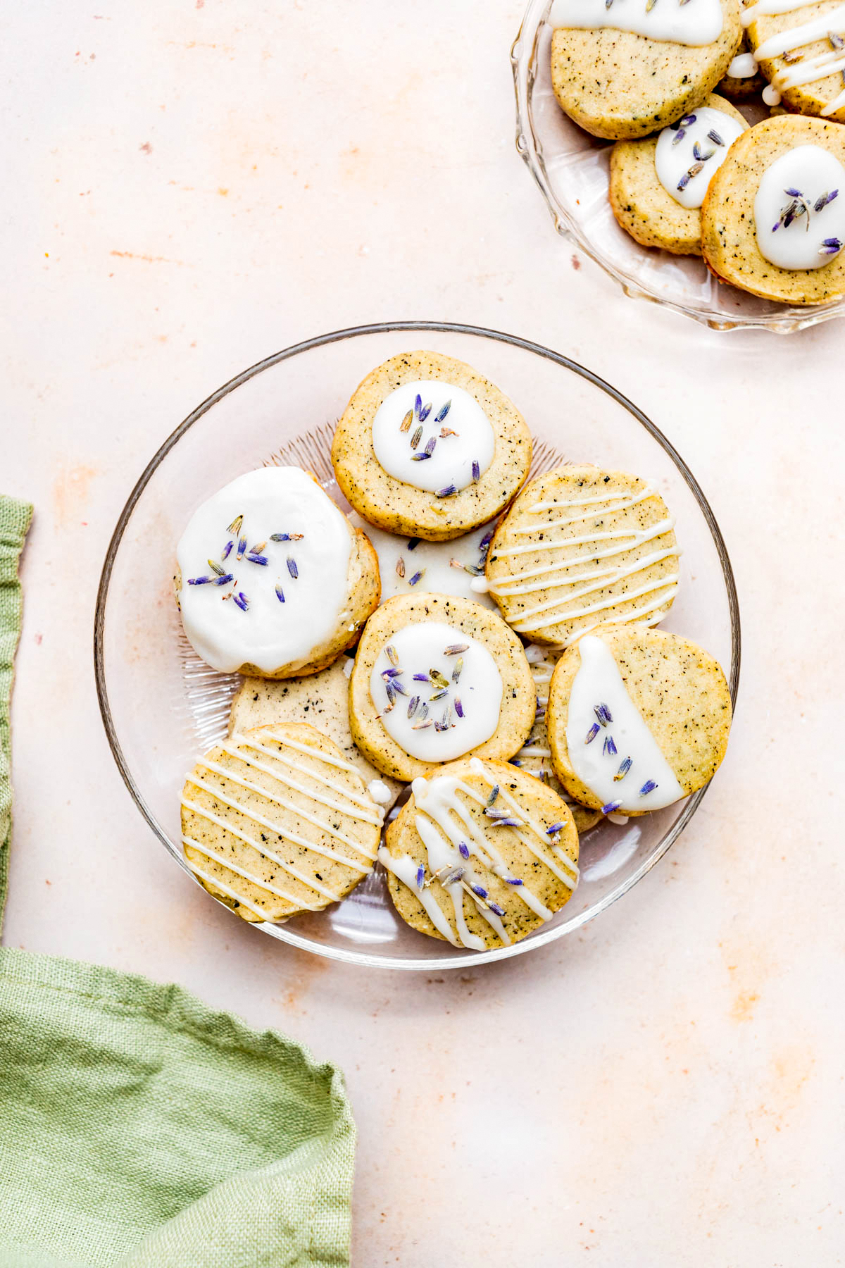 A bowl full of cookies, some with icing.