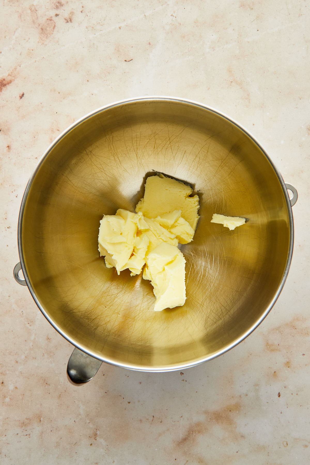 Butter in the bowl of a stand mixer.