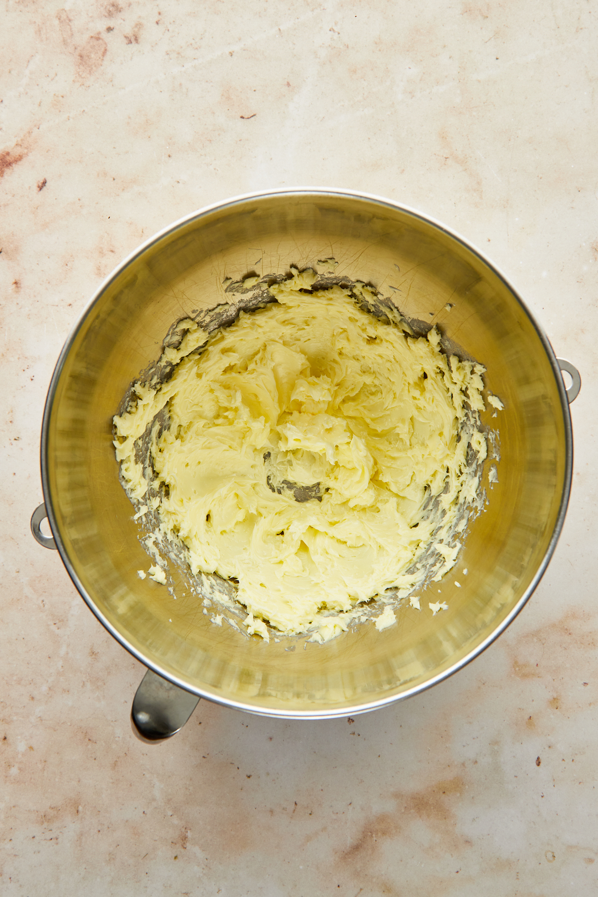 Creamed butter in the bowl of a stand mixer.