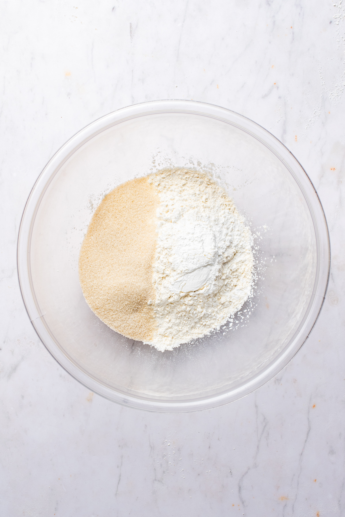 Flour, sugar, and baking powder in a large mixing bowl.