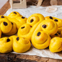 Swirled saffron buns on a wooden crate.