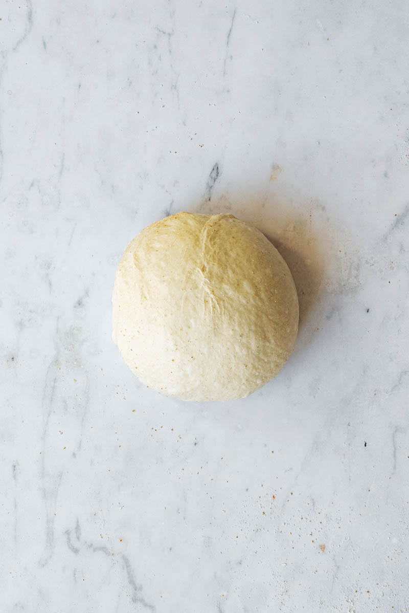 Shaped ball of dough on a work surface.