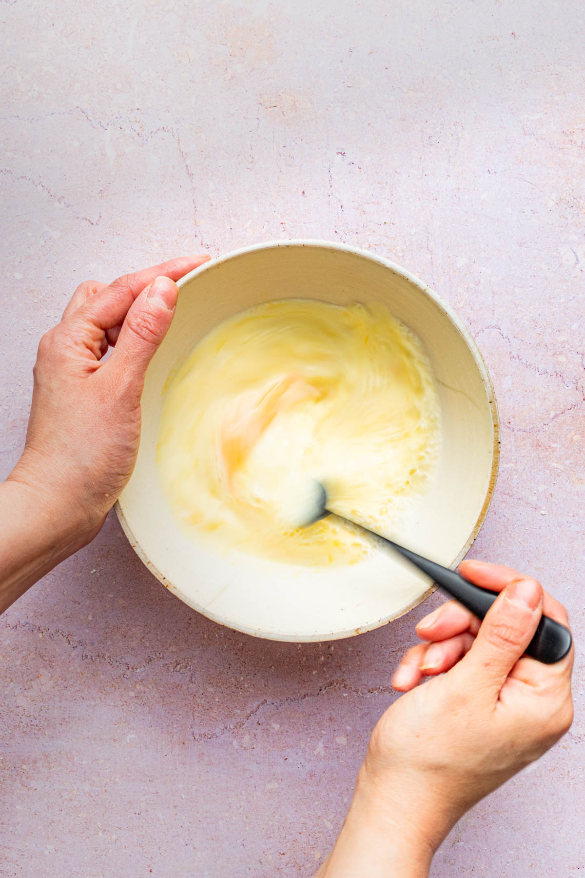 Mixing wet ingredients in a small bowl.