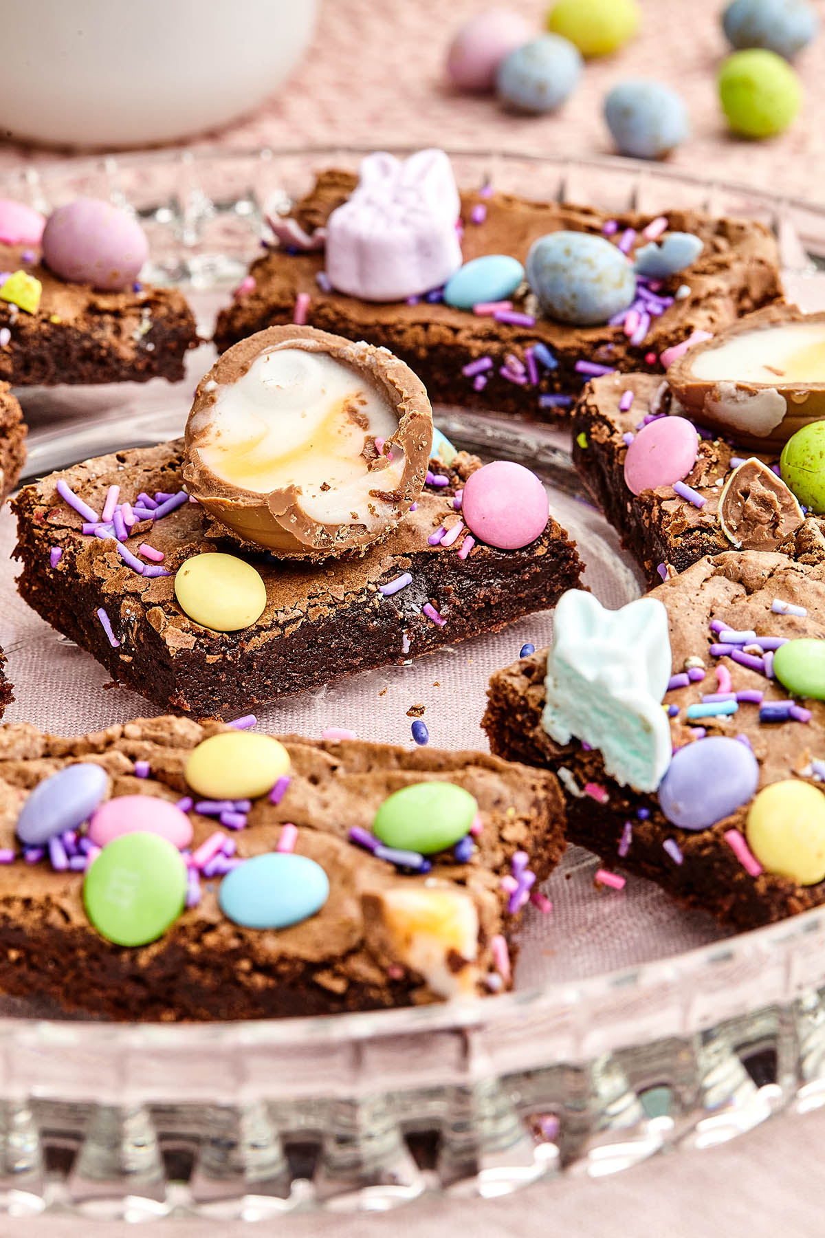 Close up of sliced Easter brownies on a glass platter.