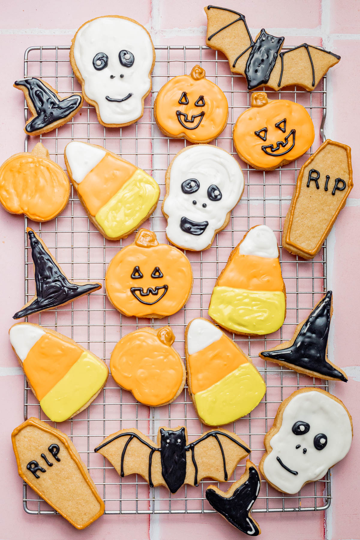 Halloween cookies after icing: candy corn, skull, coffin, witch hat, pumpkins.